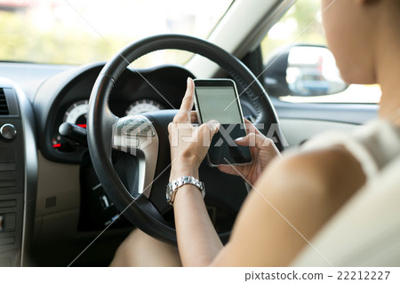 Woman use mobile phone texting while driving 22212227