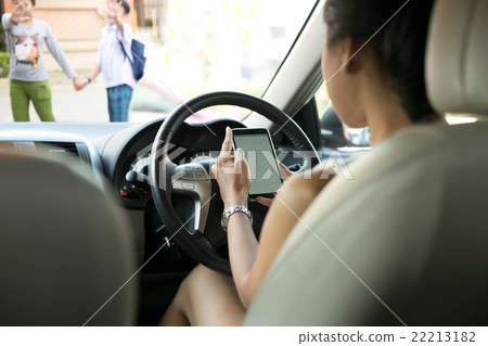 Woman used cell phone while driving Woman used cell phone while driving 22213182