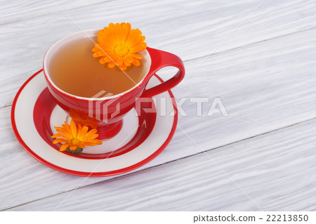 herbal tea with calendula flowers in a red cup 22213850