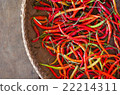 Several red and green hot chili peppers in basket 22214311
