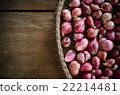 Several shallots in basket on wooden table 22214481