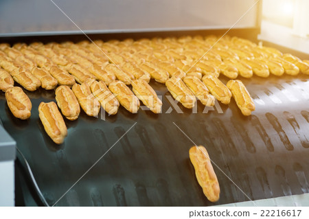 Eclairs on big conveyor. 22216617