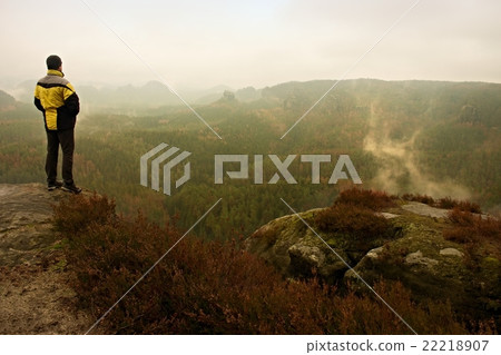 Rear view of male hiker in foggy morning Rear view of male hiker in foggy morning 22218907