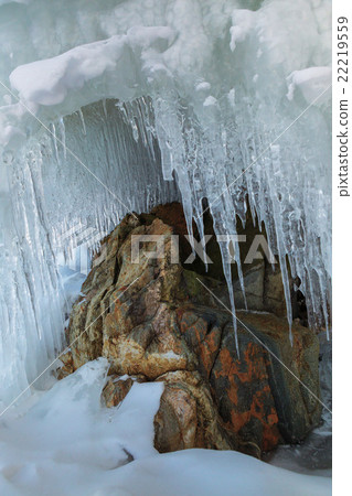 Huge icicles on a cliff. 22219559