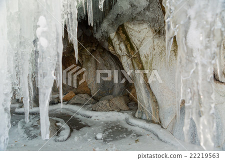 Huge icicles on a cliff. 22219563