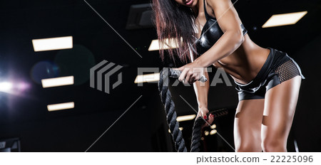 woman doing some crossfit exercises with a rope woman doing some crossfit exercises with a rope 22225096