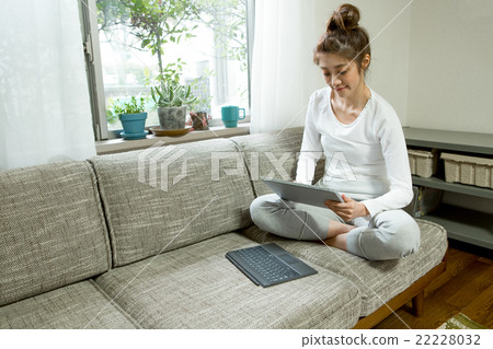 Woman relaxing in the living room Woman relaxing in the living room 22228032