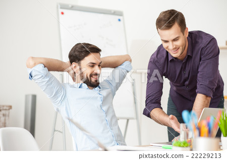 Attractive young men are working in office 22229213