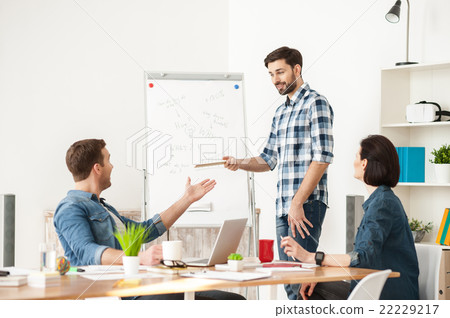 Skillful three colleagues are discussing a project 22229217