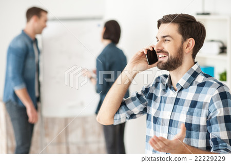 Cheerful male worker is communication on telephone 22229229