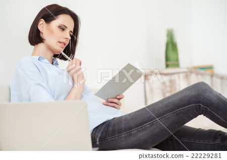 Beautiful young lady is studying at home Beautiful young lady is studying at home 22229281