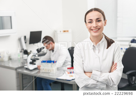 Cheerful female researcher is evincing positive Cheerful female researcher is evincing positive 22229698