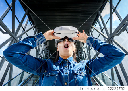 Woman wearing virtual reality glasses Woman wearing virtual reality glasses 22229762