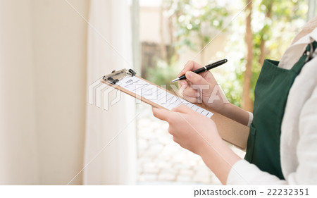 A woman in a green apron A woman in a green apron 22232351