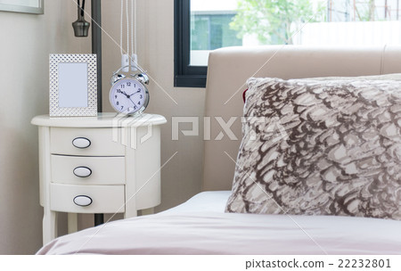 modern bedroom with bed, pillows and lamp on table 22232801