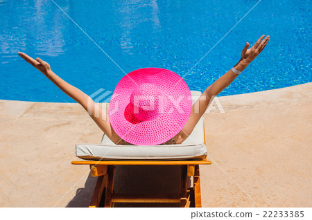 happy woman with hat sunbathing on a sun lounger happy woman with hat sunbathing on a sun lounger 22233385