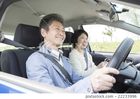 A couple in their 50s enjoying driving 22233996
