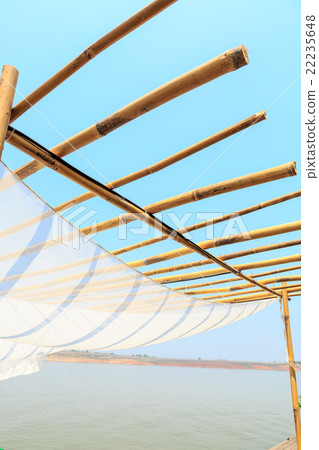 wooden with fabric roof on blue sky 22235648