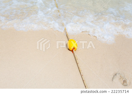 Yellow buoy on the beach 22235714