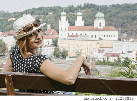 Young caucasian woman posing on the wooden bench with Saint Step 22238838