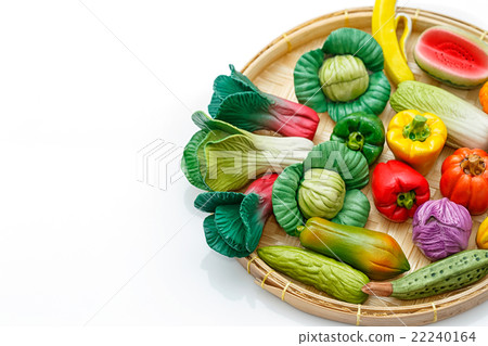 Variety of miniature clay vegetables in basket 22240164