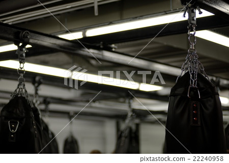 Top of many black punching bag for boxing on chain 22240958