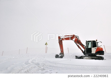 Tracklaying excavator at top of snow mountain 22240961