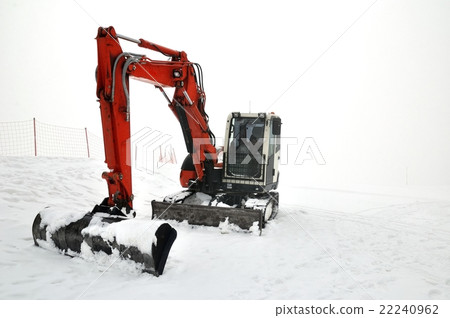 Tracklaying excavator at top of snow mountain 22240962