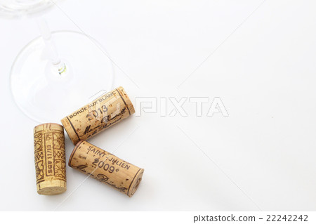Wineglass and cork left edge bouncing white back advertising space 22242242