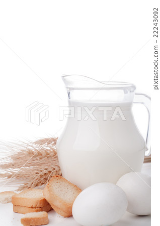 Glass jug with milk, wheat seeds and two eggs  22243092