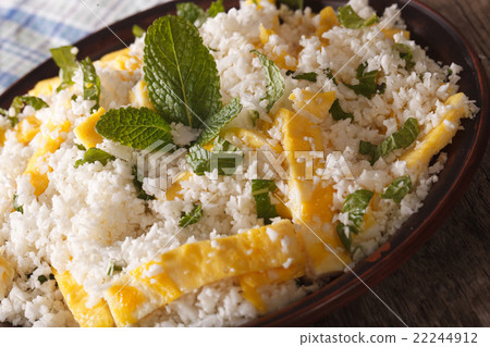 Cauliflower rice with egg and mint on a plate 22244912