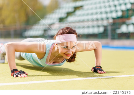 Young attractive woman doing push-up or core 22245175