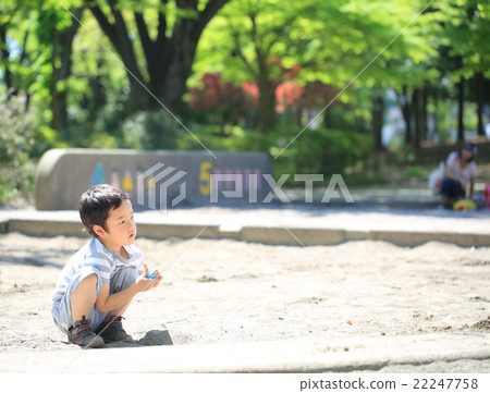 Infant playing sandbox 22247758