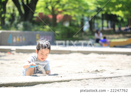 Infant playing sandbox 22247762