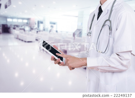Doctor working on a digital tablet in hospital Doctor working on a digital tablet in hospital 22249137