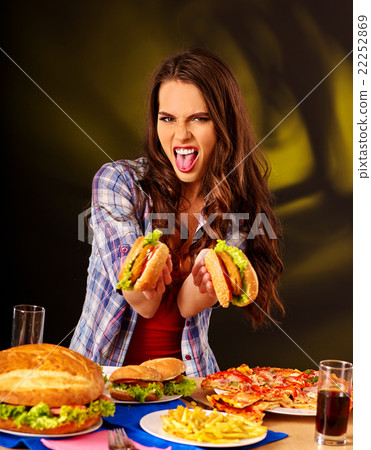 Girl eating big sandwich. 22252869