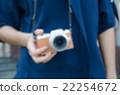 blurry girl use digital camera 22254672