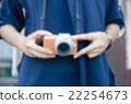 blurry girl use digital camera 22254673