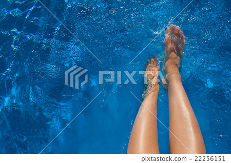 woman legs in blue water swimming pool 22256151