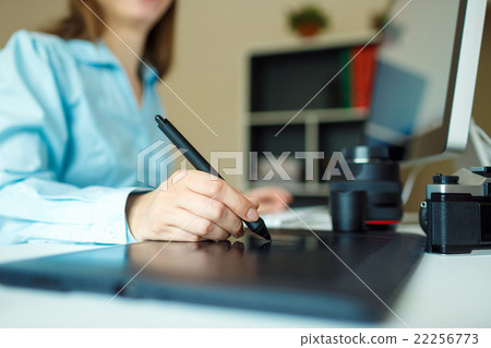 Young artist drawing something on graphic tablet at the home off Young artist drawing something on graphic tablet at the home off 22256773