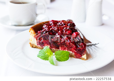 Wild berries cake with green mint on plate with fork 22257538