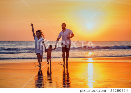 Father, mother, baby have a fun on sunset beach Father, mother, baby have a fun on sunset beach 22260824