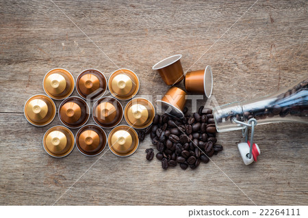 Nespresso and coffee beans on wooden background. 22264111