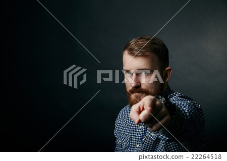 Red bearded man pointing studio portrait on dark Red bearded man pointing studio portrait on dark 22264518