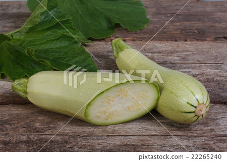 Fresh zucchini sliced with leaves on a old wooden  22265240