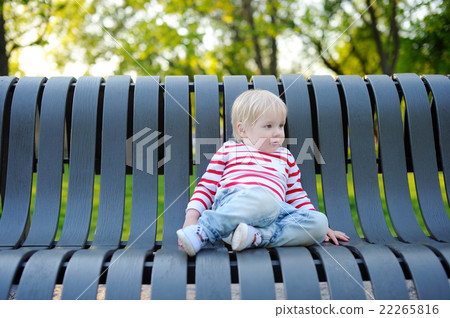 Toddler boy on a bench 22265816
