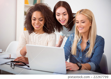 Pretty young students using the computer 22267799