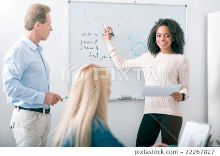 Young student answering near the blackboard 22267827