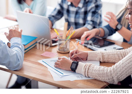 Young people sitting at the table Young people sitting at the table 22267921