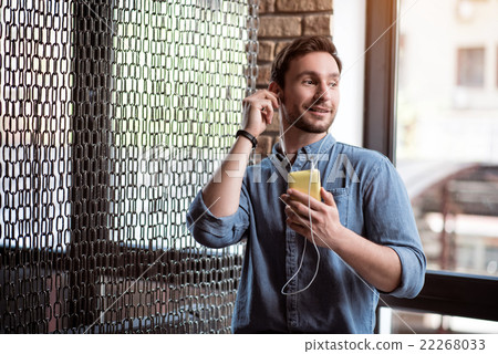 Pleasant man listening to music    22268033